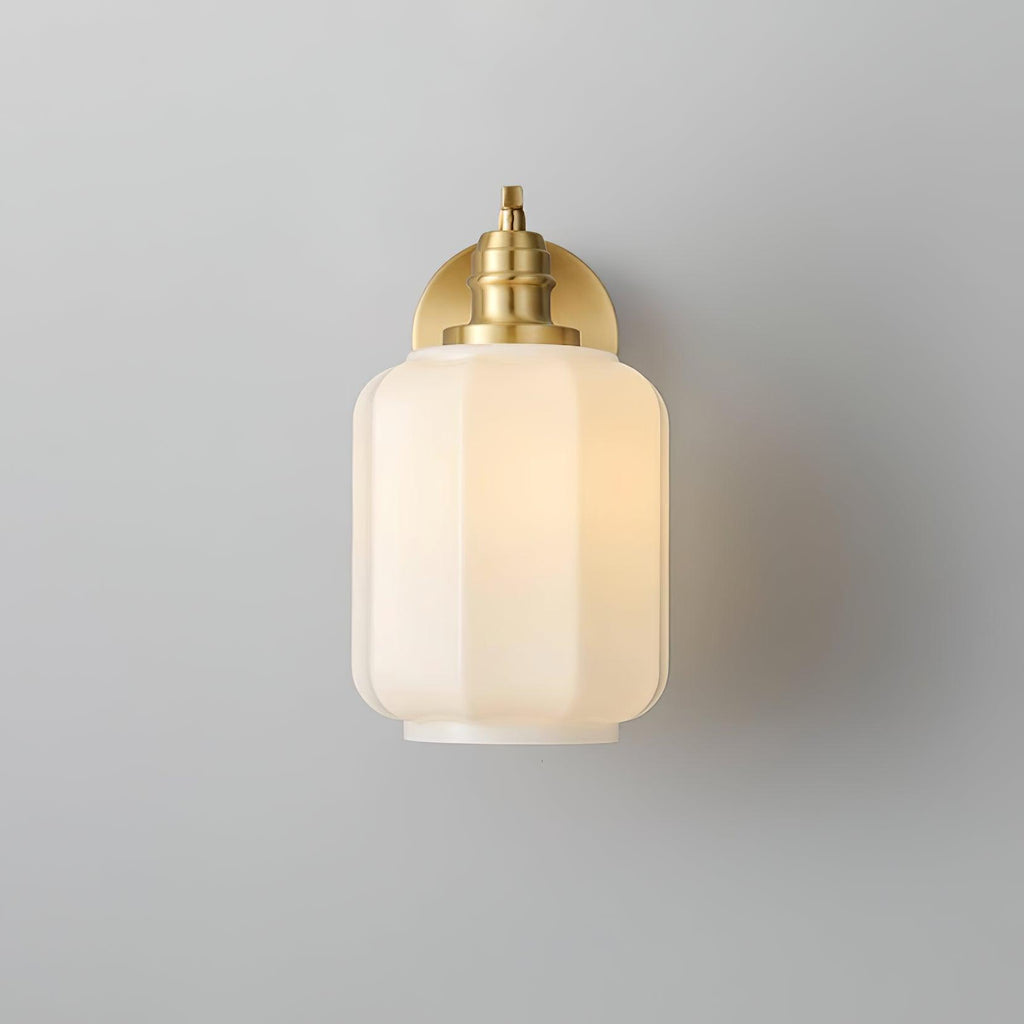 Front view of the lit Clérachic Fluted White Glass Wall Sconce, the fluted shade centred with only the brass collar showing.