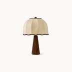 Clérachic table lamp with a cream dome fabric shade, scalloped dark trim and a fluted walnut-colour wood base, on a plain white background.