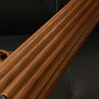 Close view of the grained, fluted wooden base of this Clérachic table lamp, with the switch near the foot.