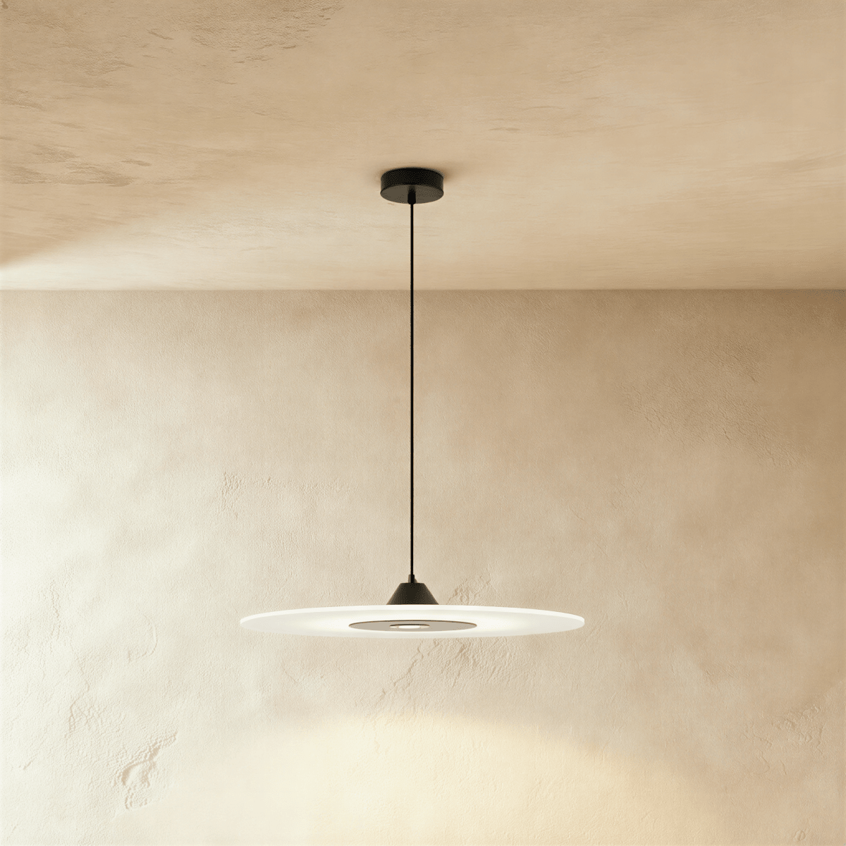 Clérachic flat frosted disc pendant with a black cone cap and dark centre panel, on a black cord against limewash plaster.