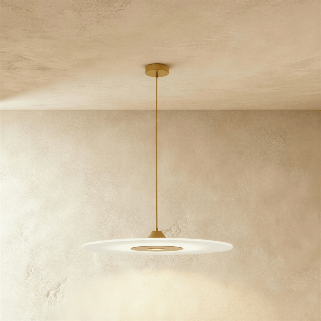 Clérachic broad frosted disc pendant in gold, its brass-toned centre panel glowing under a plaster ceiling.