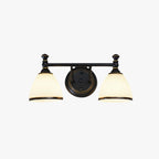 Studio front view of the two-light Clérachic frosted bell vanity light, opal glass shades rimmed in antique gold on a black bar.