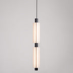 A two-head Clérachic pendant with black fittings, lit from inside, on a soft grey backdrop.