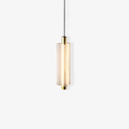A single-head Clérachic pendant with a gold cap and base, lit softly, on a pale backdrop.