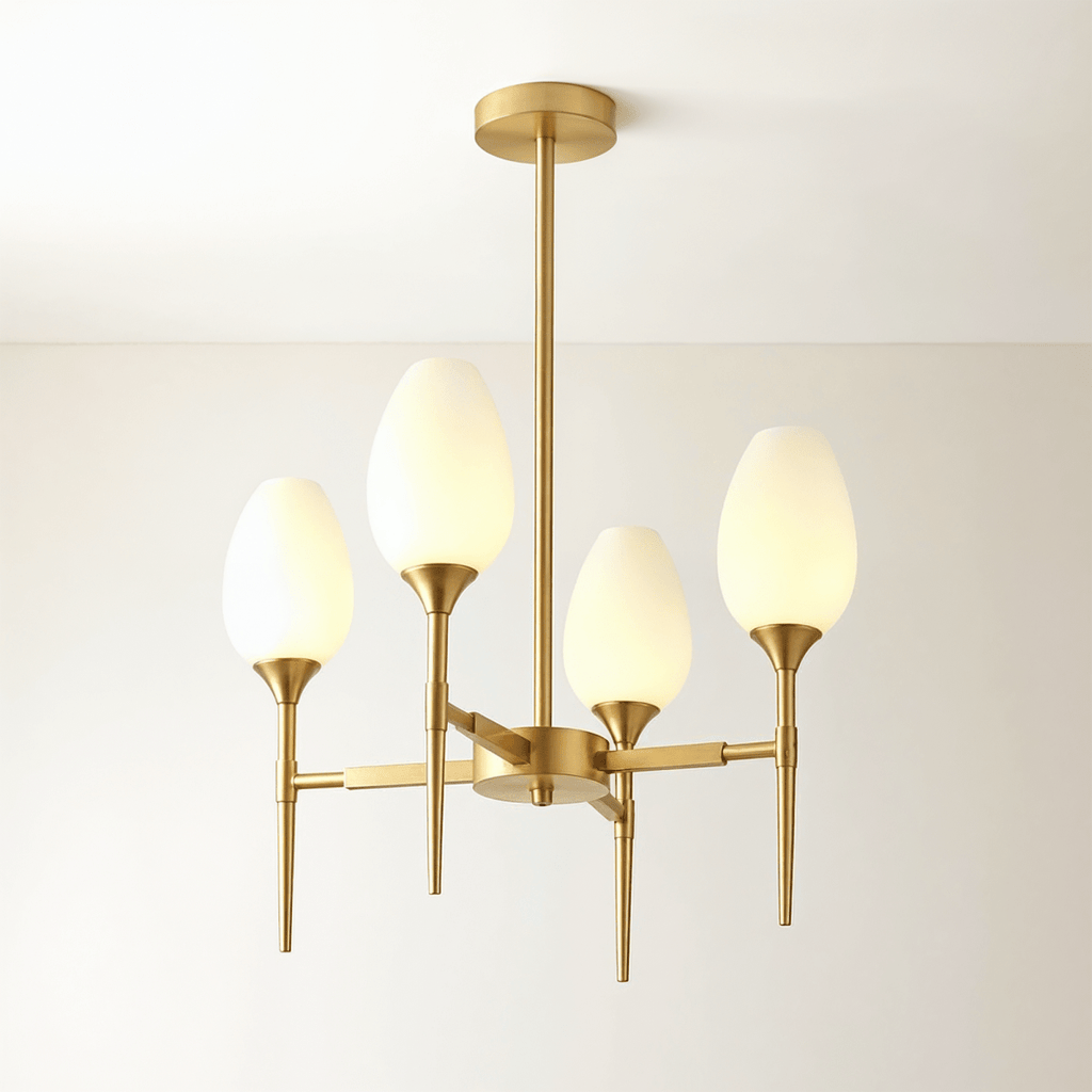 Clérachic four-arm brass chandelier with tulip-shaped frosted glass shades, lit warm, on a central brass stem and round ceiling plate.