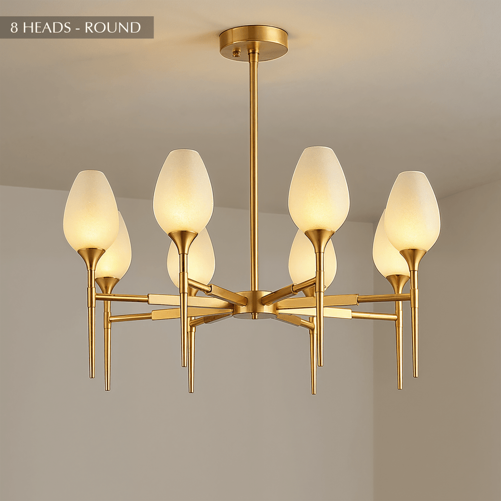 Clérachic eight-arm brass chandelier with textured frosted tulip shades, radiating from a central hub on a brass stem.