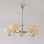 Chrome Clérachic chandelier unlit, its sand-beige glass domes and polished arms hanging below a silver canopy.