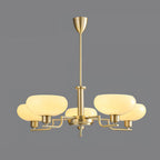 Gold Clérachic chandelier on a flat grey backdrop, five glass domes in soft cream on brass arms under a conical canopy.