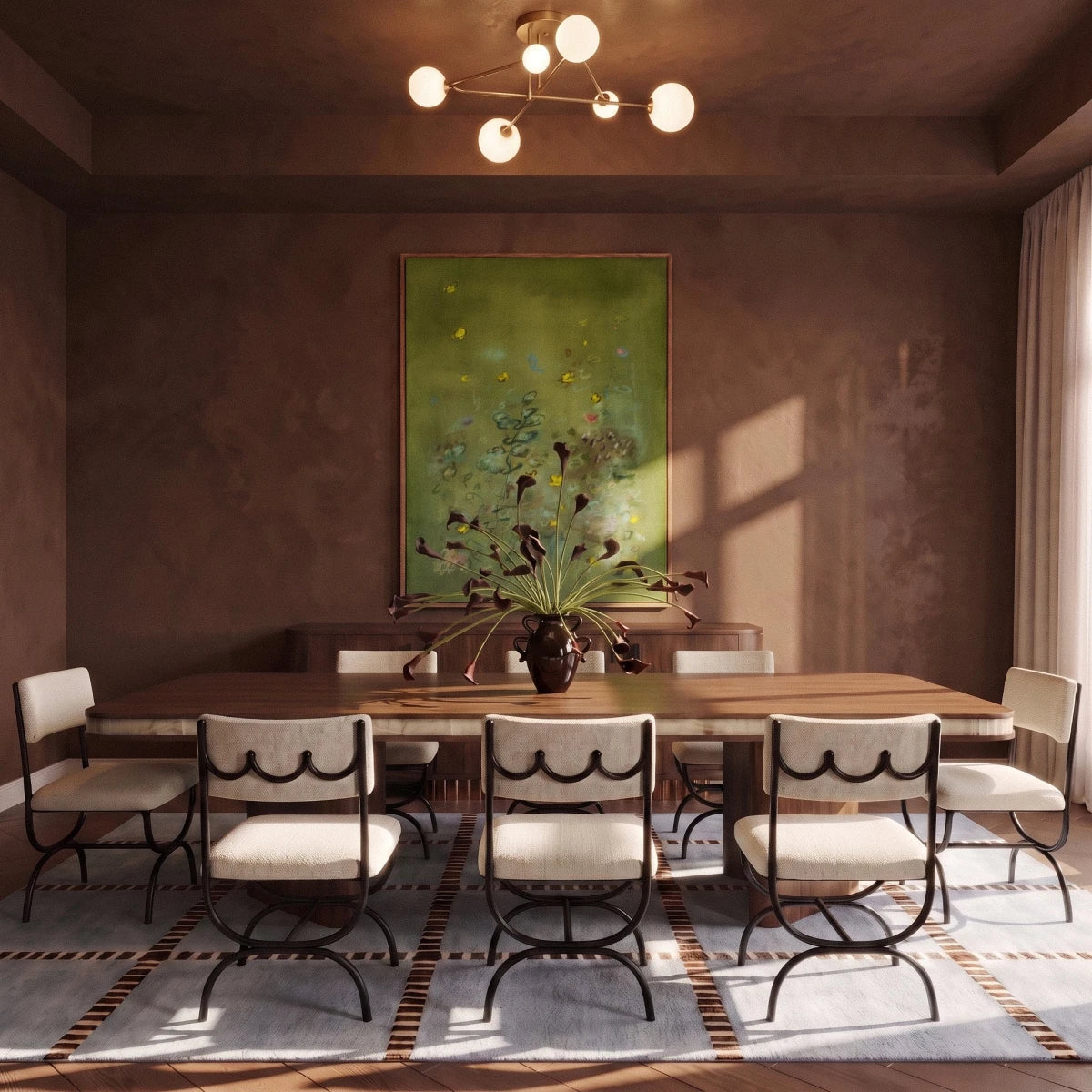 Clérachic six-head brass-toned ceiling light with frosted globes glowing above a long walnut dining table and green artwork.