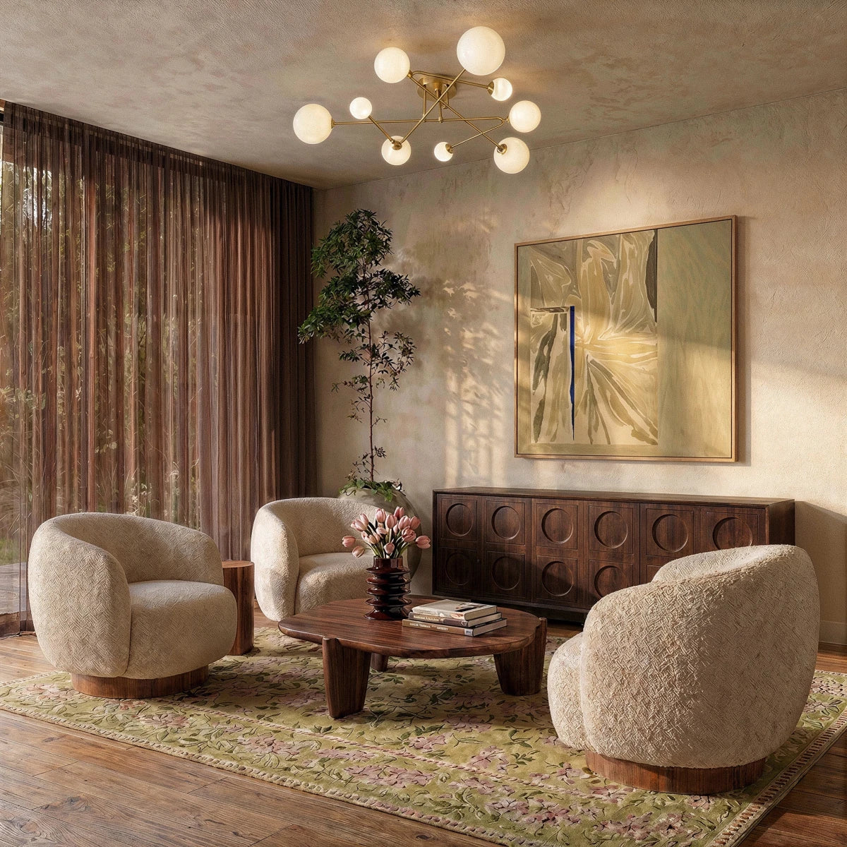 Clérachic nine-head brass-toned ceiling light with frosted globes over a living room of cream boucle armchairs and a low table.