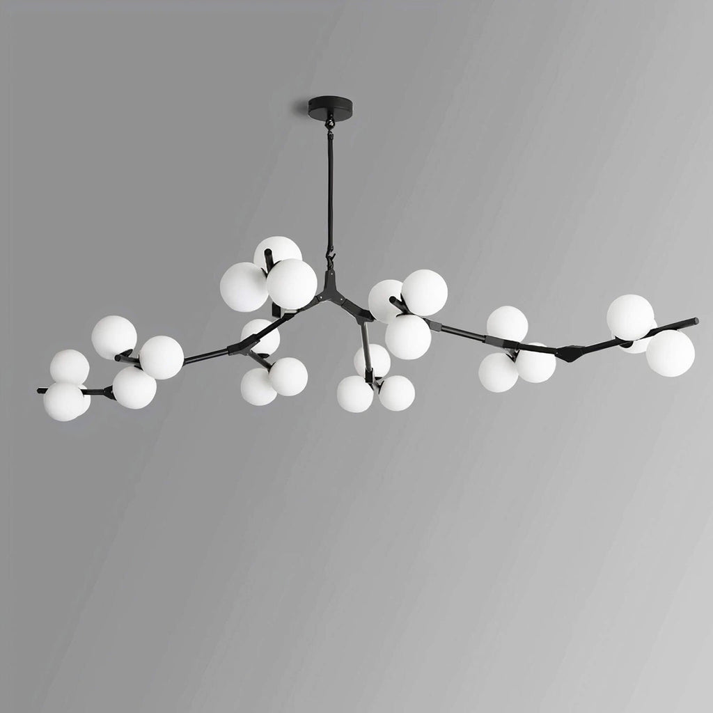 Black chandelier with a full spread of white glass globes on thin angled branches, shown on a light grey backdrop; from Clérachic.