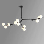 Sparser black chandelier with three long branches and frosted globes in clusters, on a grey backdrop; this Clérachic piece.