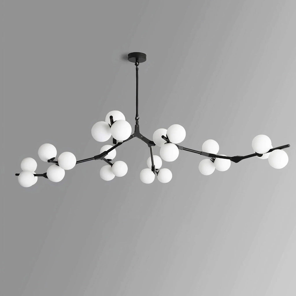 Black Clérachic chandelier with frosted globes in several clusters along its branches, unlit, on a grey gradient background.