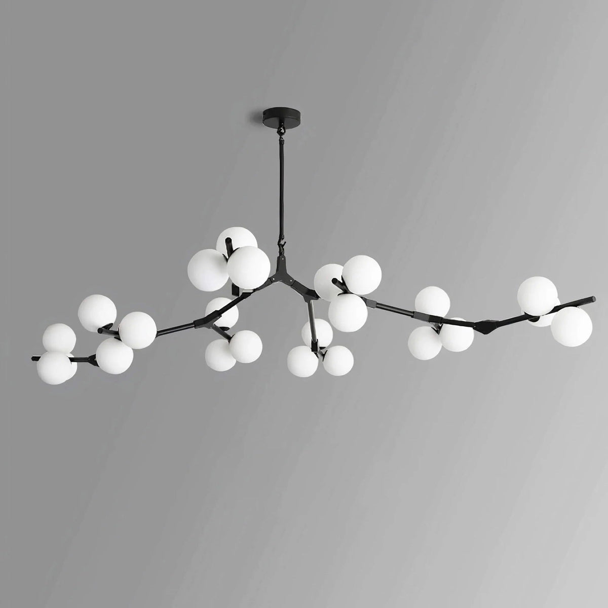 Black Clérachic chandelier with frosted globes in several clusters along its branches, unlit, on a grey gradient background.
