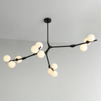 Three-armed black Clérachic chandelier from a round ceiling canopy, frosted globes lit, against a pale wall and ceiling.