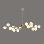 Brass-coloured branching chandelier with glowing frosted globes clustered along its arms, on a dark grey backdrop; from Clérachic.