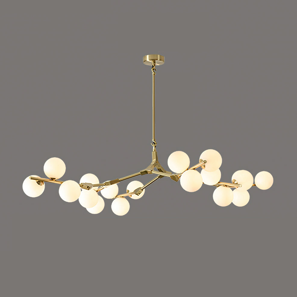 Brass-coloured branching chandelier with glowing frosted globes clustered along its arms, on a dark grey backdrop; from Clérachic.