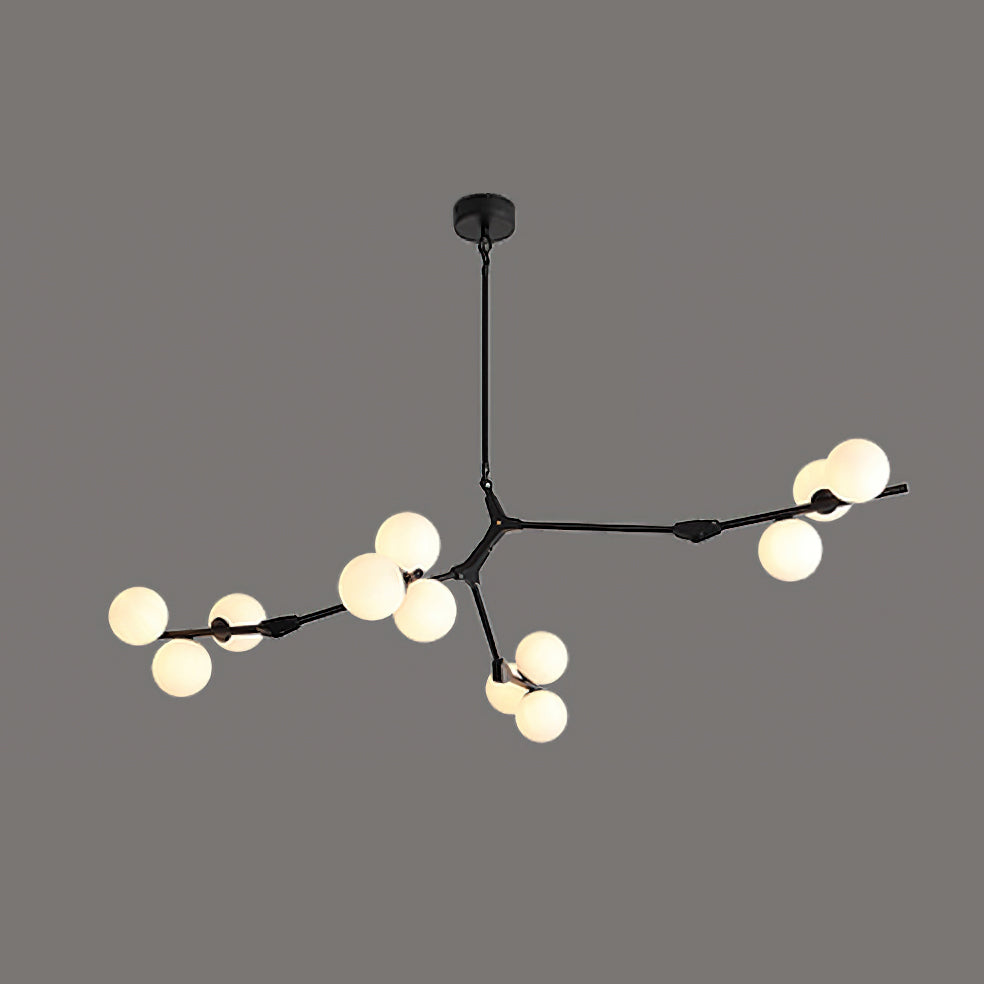 Black Clérachic chandelier lit on a dark grey background, three branches reaching out with frosted globes at their ends.