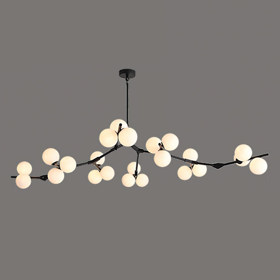 Wide black Clérachic chandelier with frosted glass globes lit in clusters along its low, spreading branches, on dark grey.