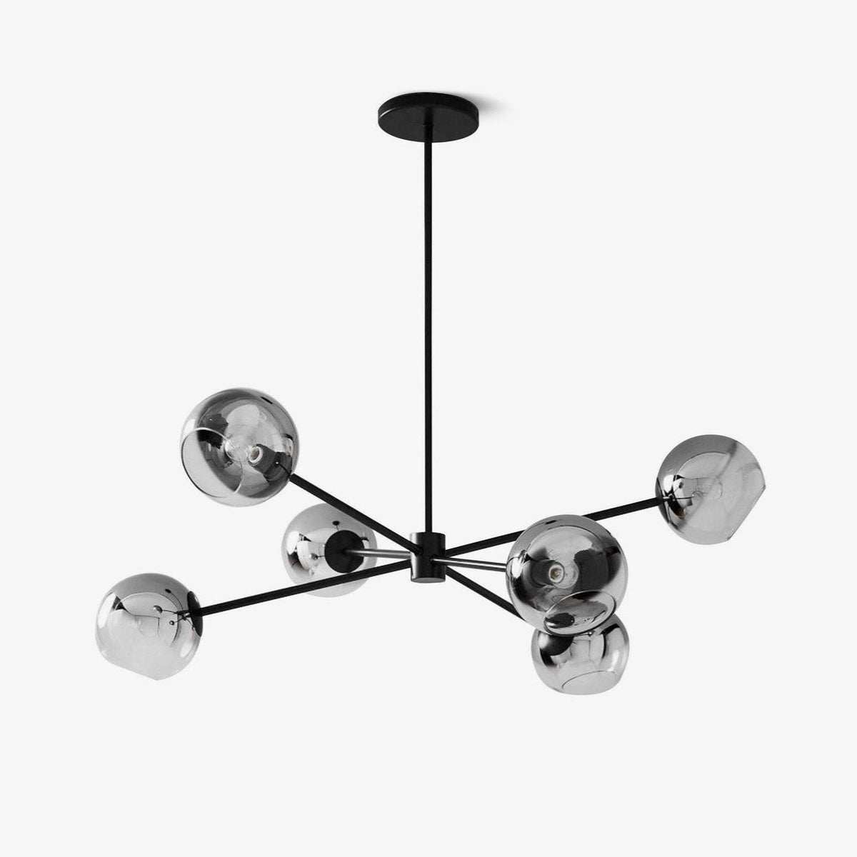 Black six-light chandelier from Clérachic with smoked glass globes on slim straight arms, hung from a round canopy on a plain white backdrop.