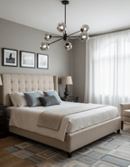 Black Clérachic chandelier with smoked glass globes in a taupe bedroom with a beige upholstered bed and framed prints above the headboard.