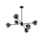 Black Clérachic chandelier with six smoked glass globes on black arms, hung from a round black canopy on white.