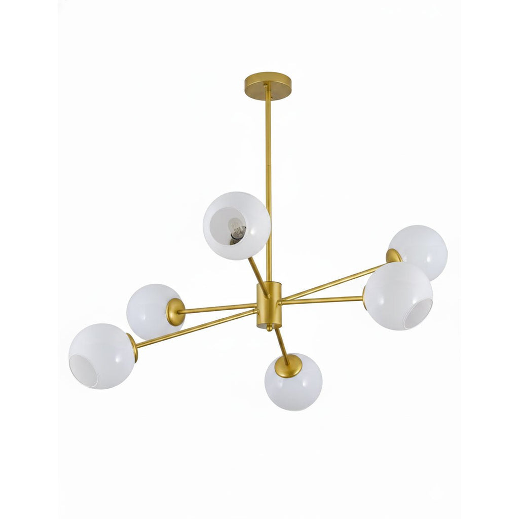 Gold-finish chandelier from Clérachic with six white globes and a gold rod, on a bright white backdrop.