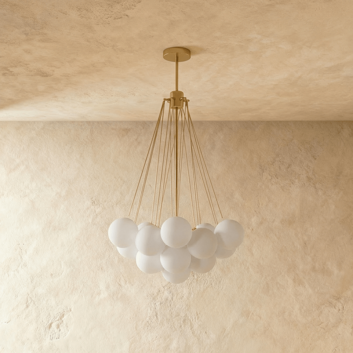 Clérachic cluster chandelier with frosted white glass spheres on slim gold-toned rods and a round canopy, shown unlit.