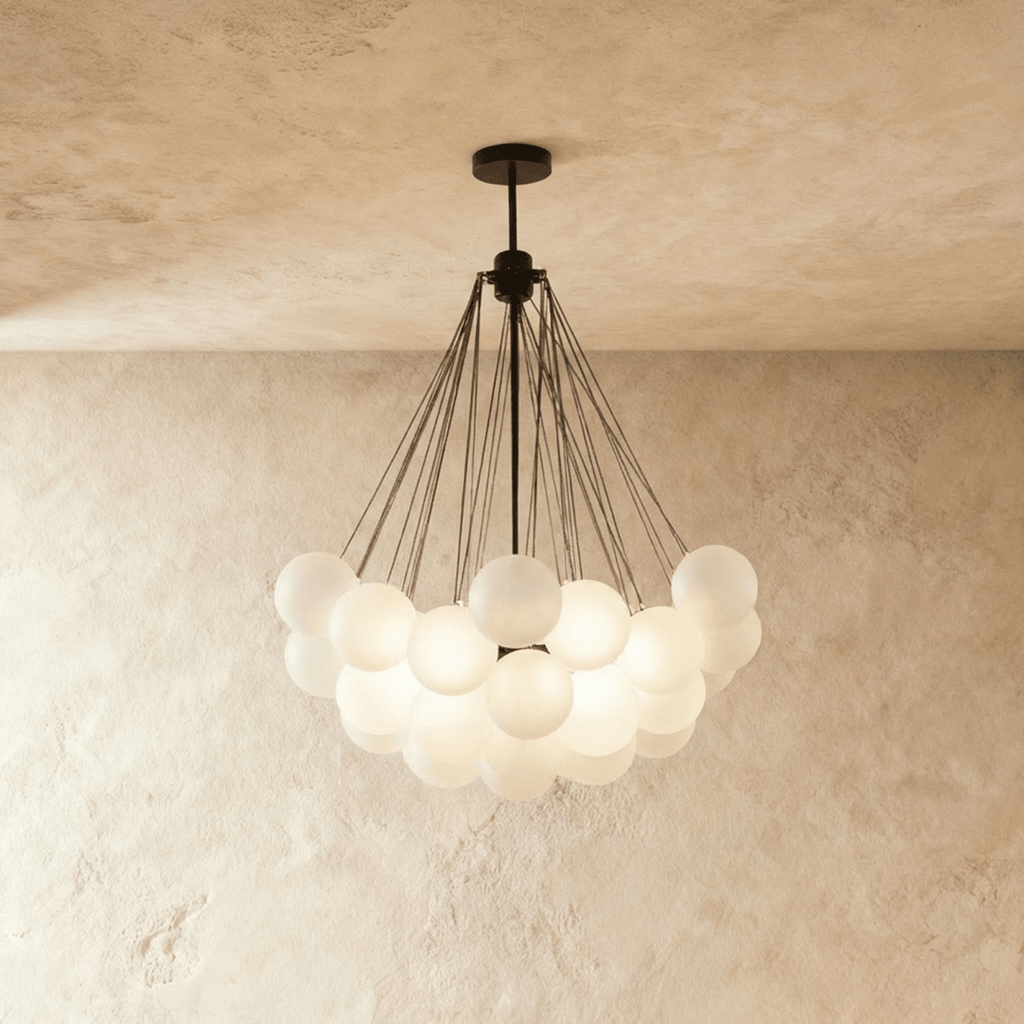 Clérachic larger cluster chandelier with many frosted glass spheres hung from black rods and a black canopy, glowing.
