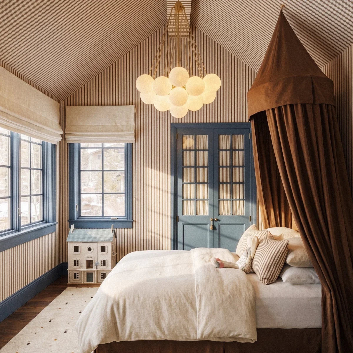 Clérachic gold-toned cluster chandelier with frosted glass spheres in a striped attic bedroom with a canopy bed.