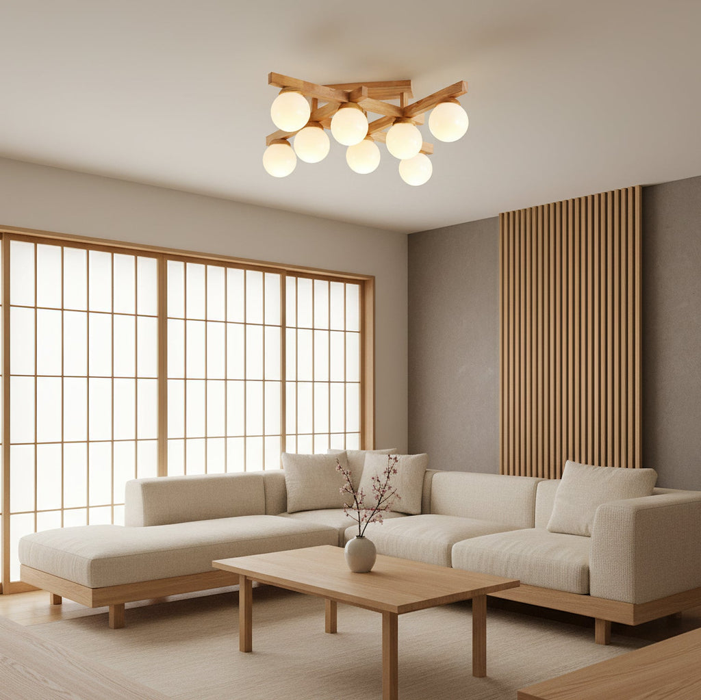 Wood-frame Clérachic ceiling light with frosted globes, lit above a low coffee table and cream corner sofa beside a timber-framed sliding screen.