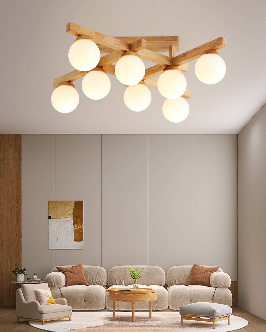 This Clérachic eight-globe ceiling light hangs above a living room with a curved beige sofa, a round wood table and a tall abstract artwork.