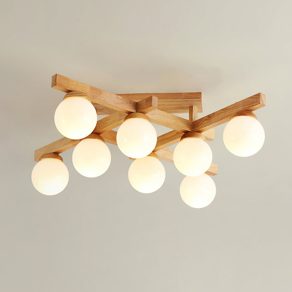 Eight frosted globes lit under a crossed wood frame, this Clérachic flush-mount light photographed against a soft grey-beige ceiling.