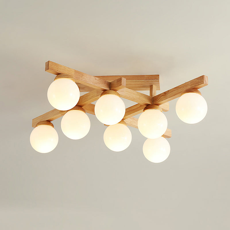 This Clérachic ceiling light with eight warm-lit frosted globes under a crossed wood frame, against a pale ceiling with a soft shadow.