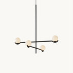 This Clérachic chandelier on a plain white backdrop, with four frosted globes on black arms off a slim central rod.