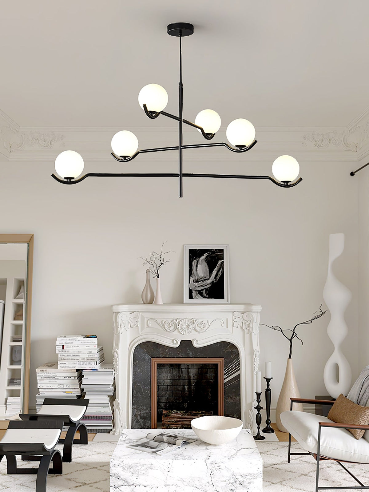 This Clérachic chandelier hangs in a living room with a marble fireplace, its six frosted globes on black arms.