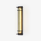 Tall rectangular outdoor wall light from Clérachic, lit warm amber inside a slim dark metal frame, on a plain white backdrop.