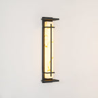 Unlit wall light on a cream wall, its pale resin shade showing soft golden veining inside a dark frame; from Clérachic.