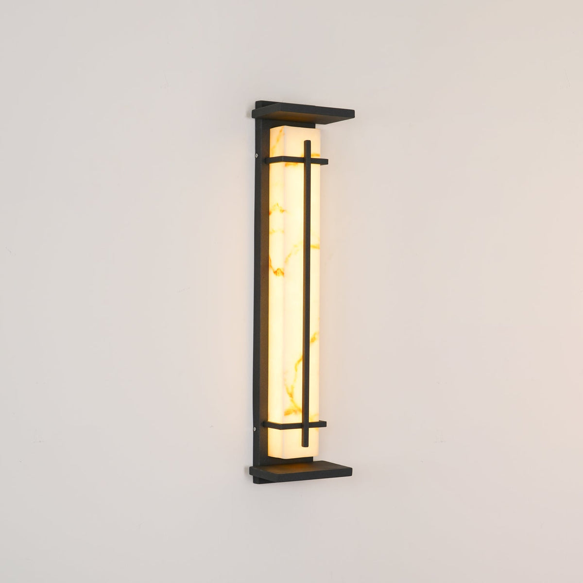 Unlit tall Clérachic wall light seen from a slight angle, showing golden veins in the pale shade and the slim dark metal frame.