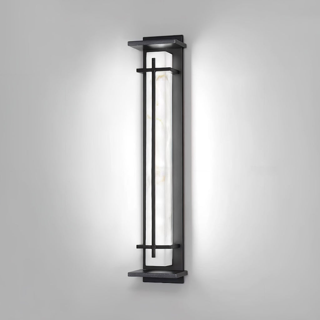 Wall light switched to a cool white, the pale veined shade bright inside the dark frame, on a grey wall; from Clérachic.