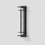 Unlit Clérachic wall light shown from a slight angle on a pale grey wall, the white marbled shade set in a dark frame.