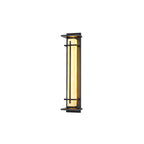 A smaller Clérachic wall light, lit warm with the glow tinted along one side, floating on a white backdrop.