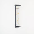 Close view of the unlit wall light, golden marks in its white shade and a grey metal frame, on a white wall; from Clérachic.