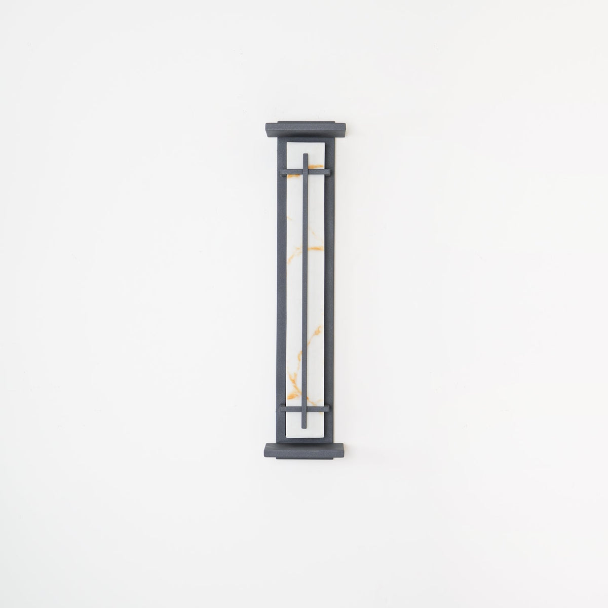 Shorter Clérachic wall light on a white wall, unlit, its pale shade with orange veining behind a slim grey frame.