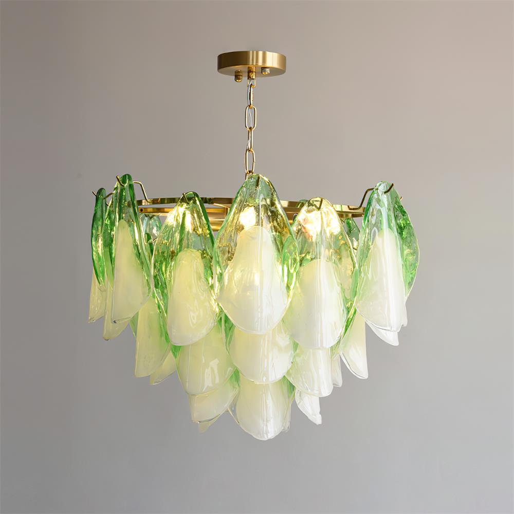 Clérachic chandelier in sage green petals photographed from a slight side angle, bulbs glowing warm.