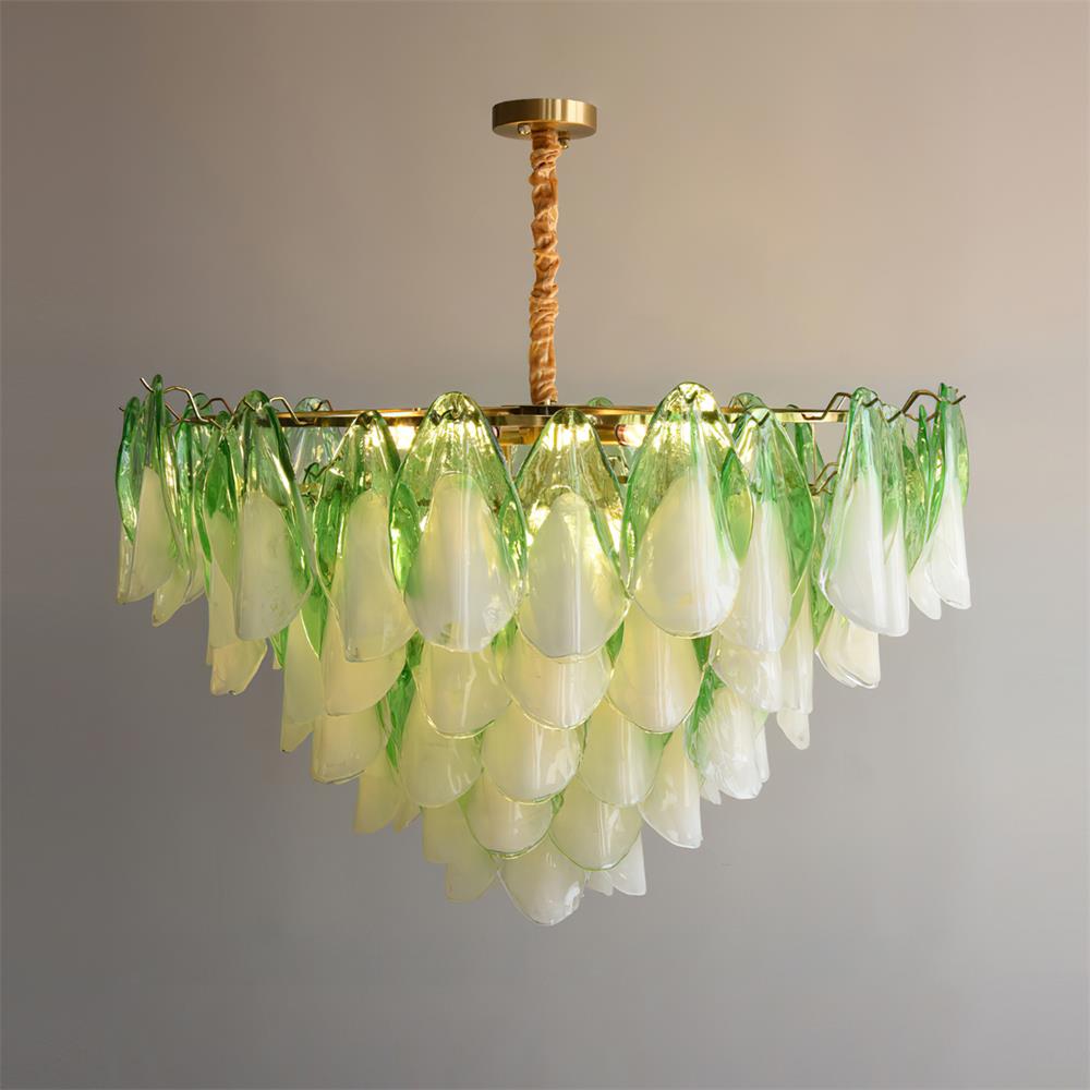 The Clérachic chandelier in sage green glass petals suspended on a twisted brass rod, lit from within.