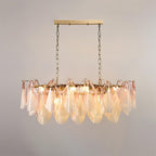 Clérachic linear chandelier in blush pink glass petals hangs from two chains for a long table.
