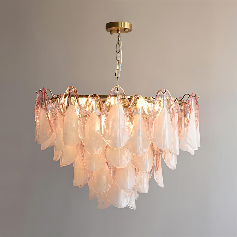 The Clérachic pendant in blush pink glass petals, lit bulbs glowing through the layered glass shades.