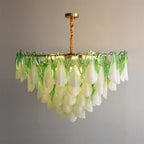 Clérachic chandelier in sage green glass petals on a twisted brass rod, glass edges catching the light.