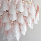 Clérachic close-up of blush pink glass petals layered thick, brass hooks visible at the top edge.